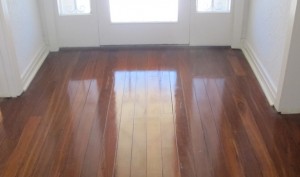 Old style timber floor restored - hallway setting The rich colours of hardwood Jarrah with highly polished surface restored by Profloors